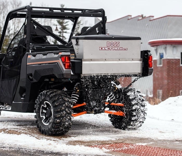 BOSS EXACT PATH drop spreader mounted on a UTV