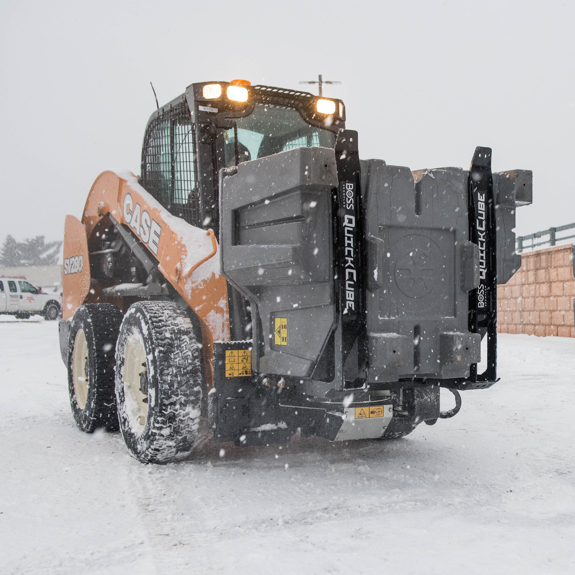 BOSS QUICKCUBE spreader mounted on a skid steer